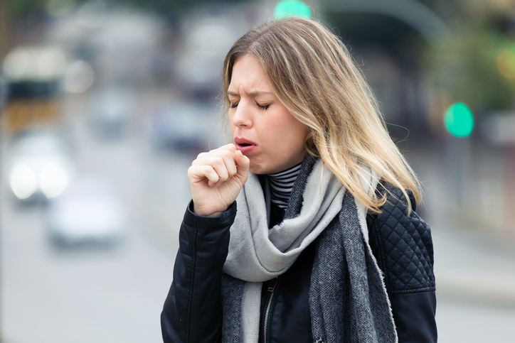 young woman coughing